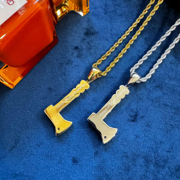 Back view of gold and silver axe pendant necklaces, engraved with 'Always eXcel in Everything,' hip hop motivational jewelry