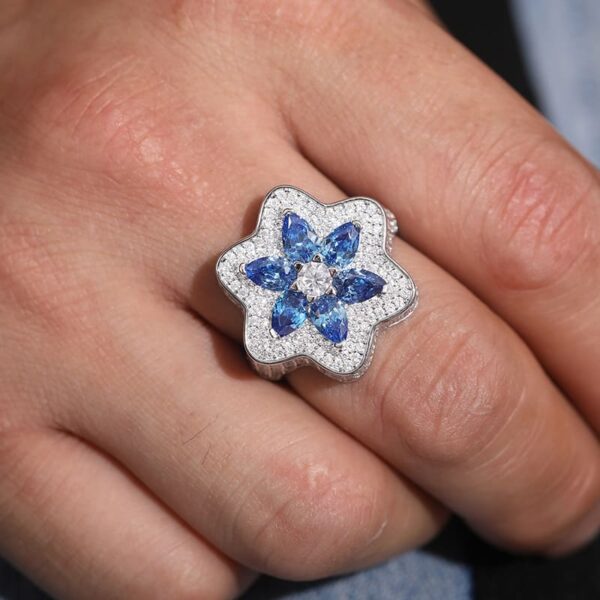 Sterling silver Klein blue moissanite flower ring worn by model, trendy iced out hip hop jewelry