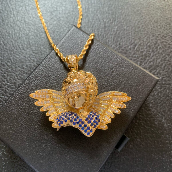 Front view of ICETOPLUXE gold blindfold angel pendant featuring blue and white CZ diamonds, perfect for hip hop jewelry enthusiasts