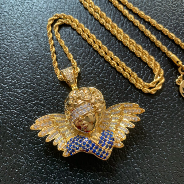 ICETOPLUXE gold blindfold angel pendant necklace close-up, front view with blue and white CZ diamonds, hip hop charm jewelry for men