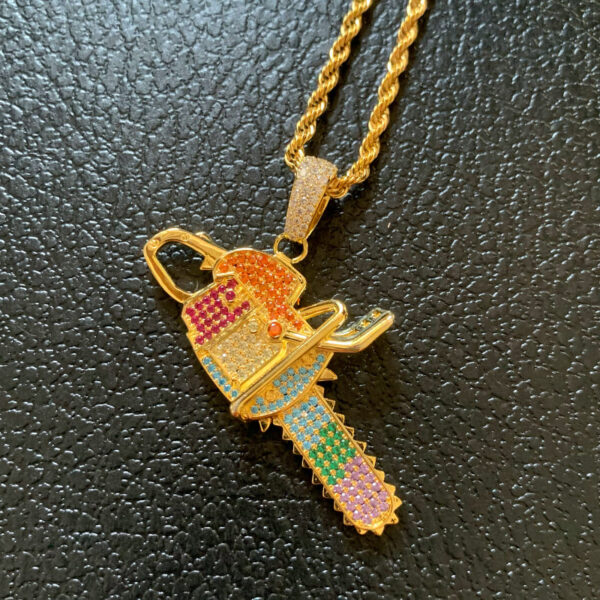 ICETOPLUXE gorgeous gold chainsaw pendant necklace beautifully displayed, perfect for any hip hop outfit