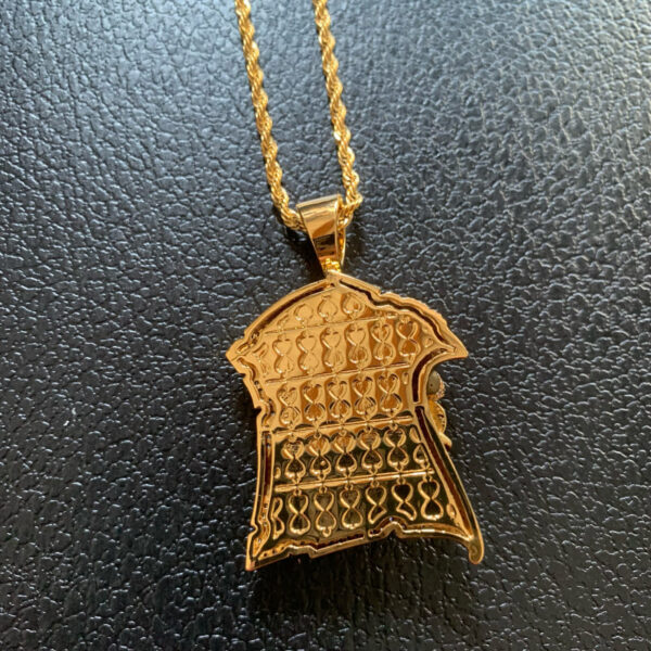 ICETOPLUXE Back view of gold King Assassin pendant, showcasing craftsmanship and logo, ideal for hip hop jewelry lovers