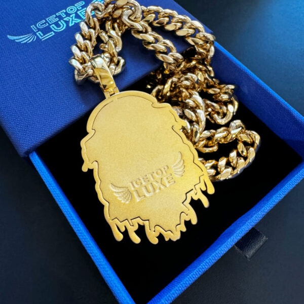 Back view of ICETOPLUXE gold Lion head pendant, engraved with ICETOPLUXE logo, featuring wings and text