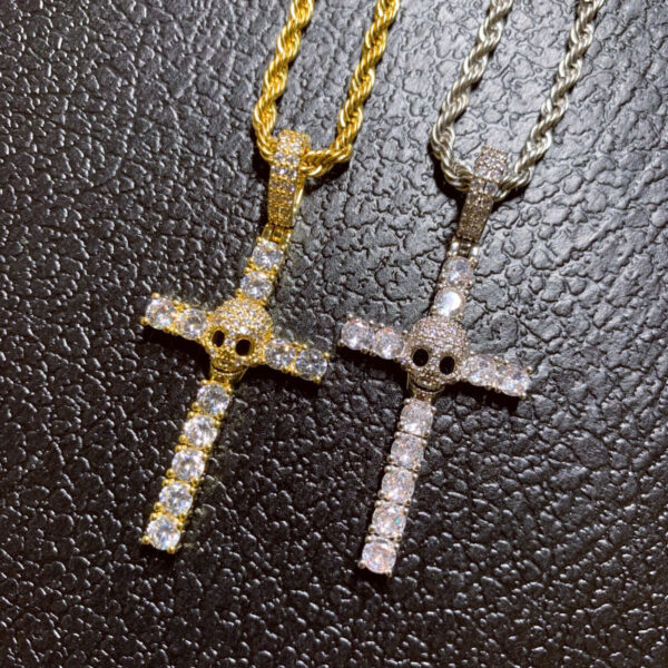 ICETOPLUXE real photo of gold and white iced out skull cross pendants showcasing stunning charm jewelry