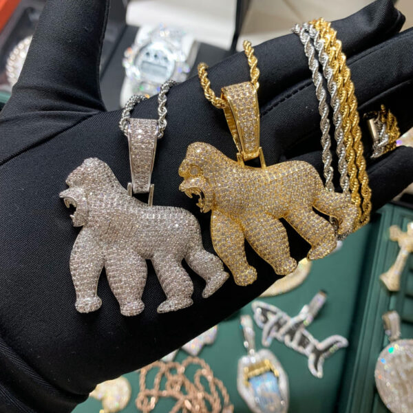 ICETOPLUXE gold and white roaring gorilla pendants side by side, showcasing stunning designs