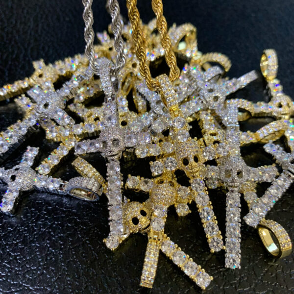 ICETOPLUXE display of iced out skull cross pendants, ideal for unique hip hop charm jewelry