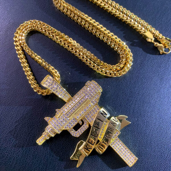 ICETOPLUXE iced out Uzi gun pendant paired with a 24'' Franco Square Box Link chain, showcasing bling style