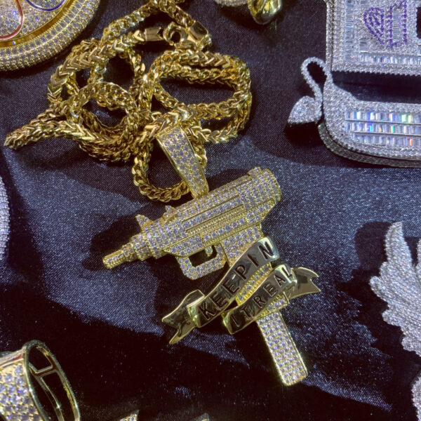 ICETOPLUXE iced out gun pendant on a Franco Square Box Link chain, perfect for men's hip hop fashion