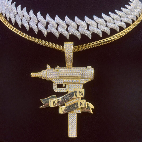 ICETOPLUXE model showcasing iced out gun pendant layered with Franco Square Box Link chain and Cuban chain