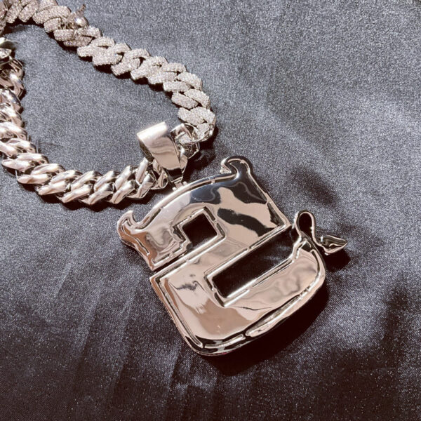 ICETOPLUXE real shot showing back of S letter iced out pendant, a stylish choice for hip hop lovers