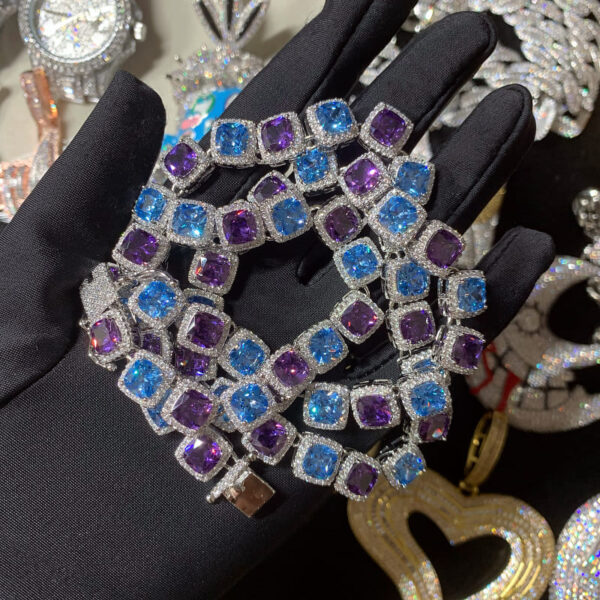 ICETOPLUXE iced out tennis chain necklace held in hand, featuring vibrant blue and purple zircon stones for hip hop fashion