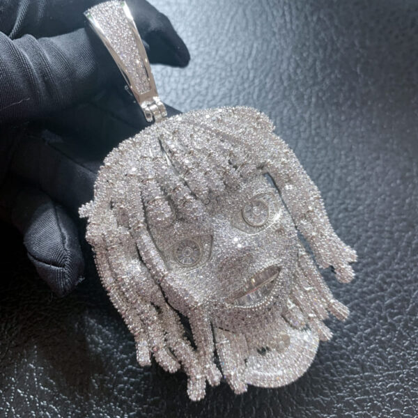 ICETOPLUXE close-up of white iced out dreadlocks pendant, showcasing intricate details and shine