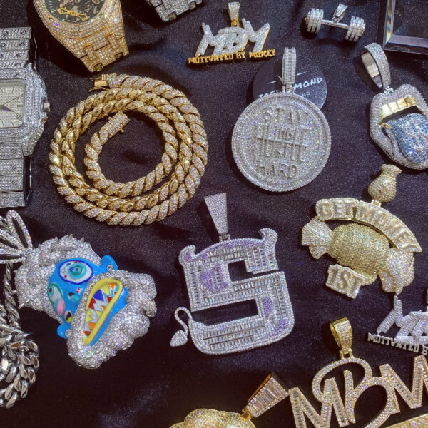 ICETOPLUXE white Mysterious Tribe Chief pendant displayed alongside other pendants from the ICETOPLUXE hip hop jewelry collection