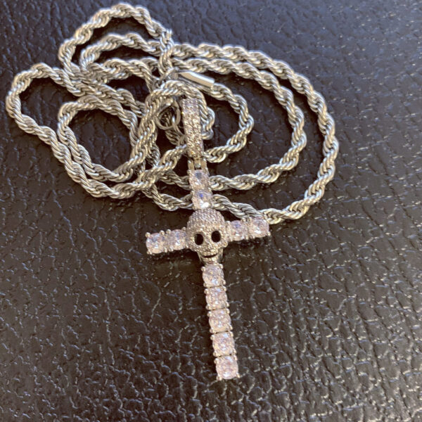 ICETOPLUXE showcase of a single white skull cross pendant, iced out with 5A CZ diamonds for men