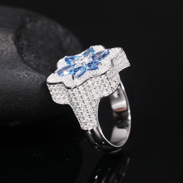 Side view of silver Klein blue moissanite flower iced out ring, custom jewelry for men and women