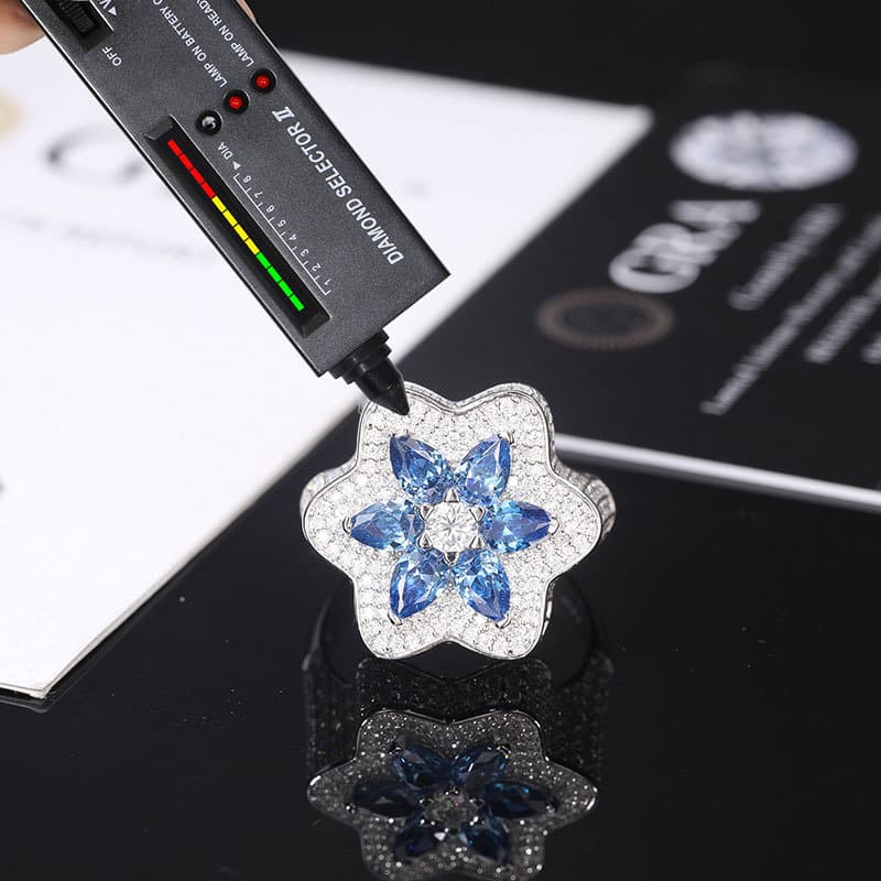 Detailed front view of silver Klein blue moissanite flower ring, ideal for rapper and hip hop lovers